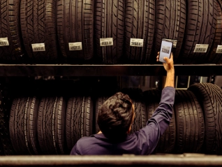 Automotive worker checking tyres